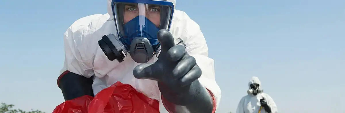 sewage clean up technician wearing protective gear handling biohazard materials in Baton Rouge, LA